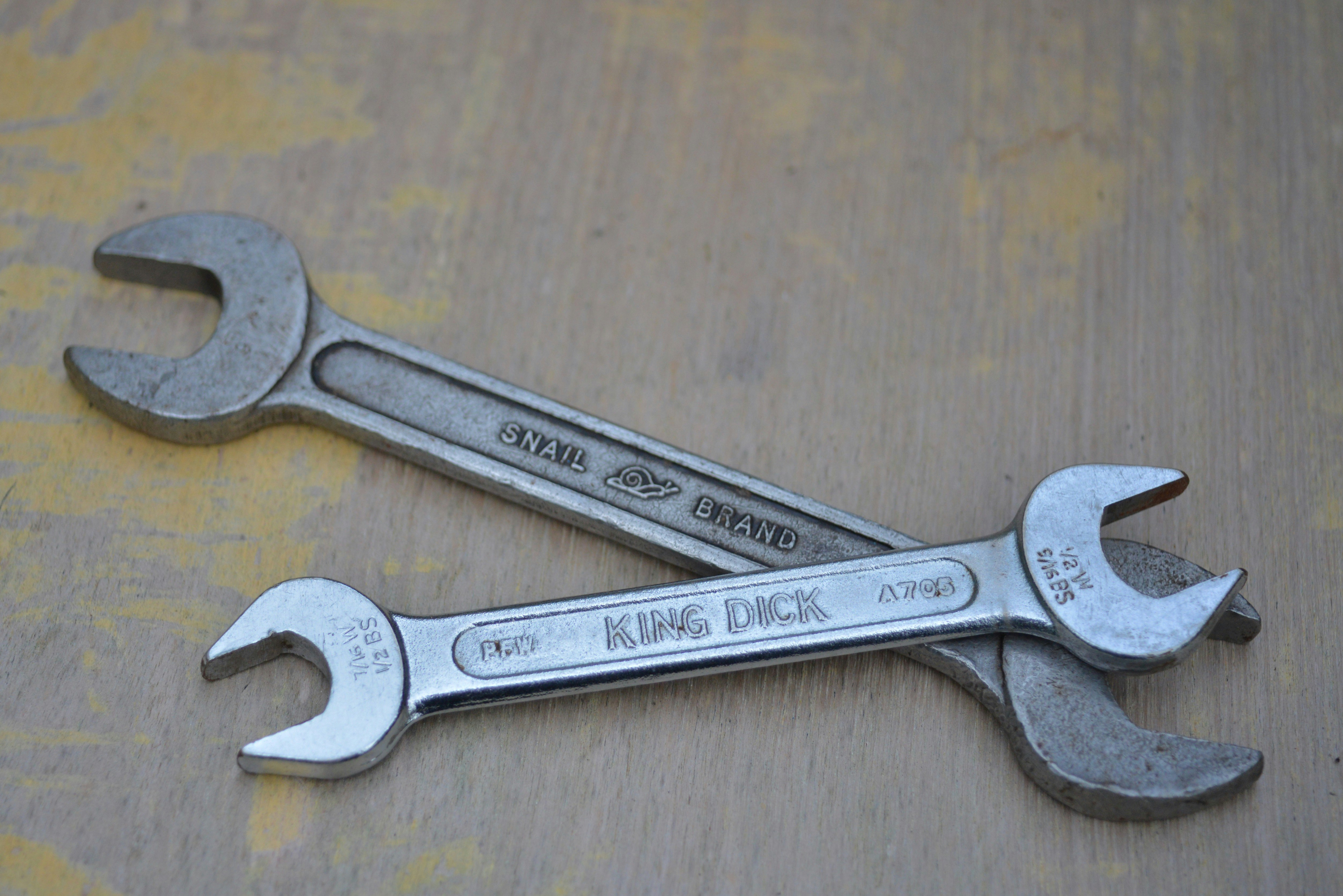 silver steel measuring spoons on brown wooden table